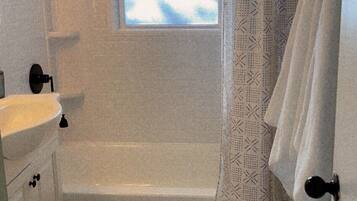 Combined shower/tub, hair dryer, towels, soap