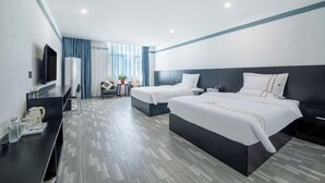 A modern hotel room with two beds, a desk with a TV, and a small seating area. - Duyun Star Boutique Hotel (Weinan Vocational and Technical College) (Duyun)