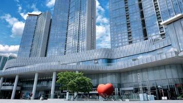 A modern building with a curved facade and multiple tall structures.