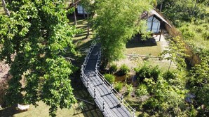 A suspension bridge in a lush, green environment. - Beachside 2 (Binga)