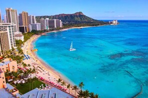 A coastal cityscape with a beach, high-rise buildings, and a mountain in the background. - Waikiki retreat w/ pool, BBQ & skyline views (Honolulu)