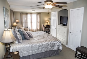 A bedroom with a bed, bedside lamps, a ceiling fan, a TV, a desk, and a wardrobe. - 🌄 Resort Vacations at Fairfield Glade TN Best View on the Lake 2 bedroom /2 bathrooms (Fairfield Glade)