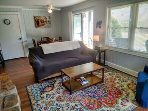 Relax in this inviting living space with a sofa, coffee table, and dining area.