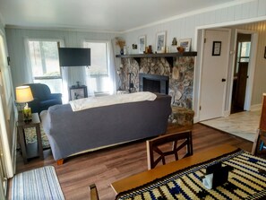 Relax in this inviting guest room with a large bed, flat-screen TV, and stone fireplace.