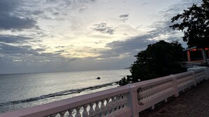 A coastal view with a balcony railing overlooking the sea. - Best Location, Caribbean views, Off street parking, walk everywhere. (Vieques)