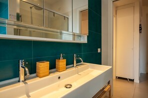 A bathroom with a white sink, two faucets, and a wooden soap dispenser. - Elisa apartment Sistine Chapel (Roma)