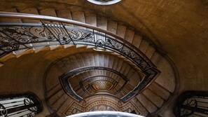 A spiral staircase with ornate metal railings and stone steps. - Italianway - Montello 10 - D (Milan)