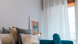 A neatly made bed with rolled towels, a bedside lamp, and a framed artwork on the wall. - Suitur Milenium apartment Marbella beach Venus (MARBELLA)