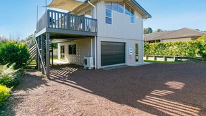 A two-story house with a balcony, a garage, and a covered outdoor area. - Mercy of Lake Taupo- family time + lake time (Taupo)