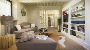 A cozy living room with a sofa, a coffee table, and a bookshelf filled with books. - La Dama Del Bosco 8 3 (Pietrasanta)