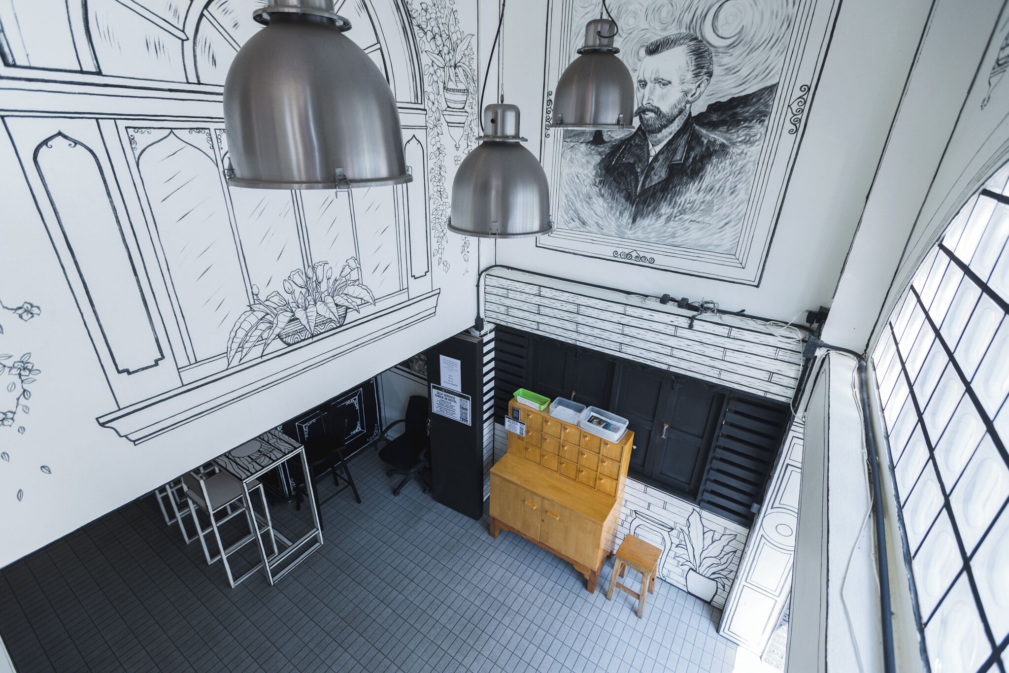 A room with a kitchenette, a wooden cabinet, and a large window.