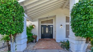 A building entrance with a dark door, white walls, and a stone pathway leading to it. - WALK TO LA-WHITE SOX SP TRAINING 5MN DRIVE 2 STADIUM 1AC YARD +4Ksq ft HOME (Glendale)