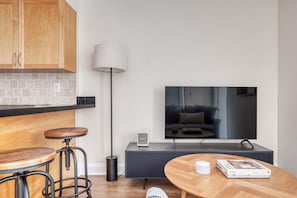 Cozy living space with a kitchen, dining area, and entertainment unit.