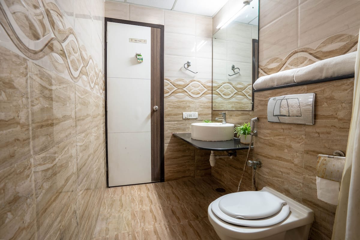 deluxe room | bathroom | shower, rainfall showerhead, free toiletries, towels
