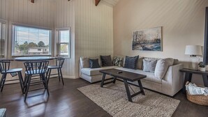 A living room with a sofa, chairs, a coffee table, and a painting on the wall. - Canyon View Ski House | Sleeps 14 + Hot Tub (Cottonwood Heights)