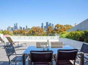 Outdoor dining - Cosmo Stays- 3BR Penthouse Apartment. Incredible City Views. Free Parking. (Carlton)