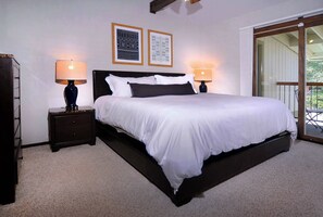 A bedroom with a large bed, two bedside tables with lamps, and two framed wall decorations. - Dogwood at Outrun - 3 BR, Hot tub, Shuttle (Mt. Crested Butte)