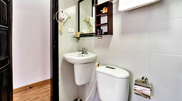 A bathroom with a sink, mirror, and toilet.
