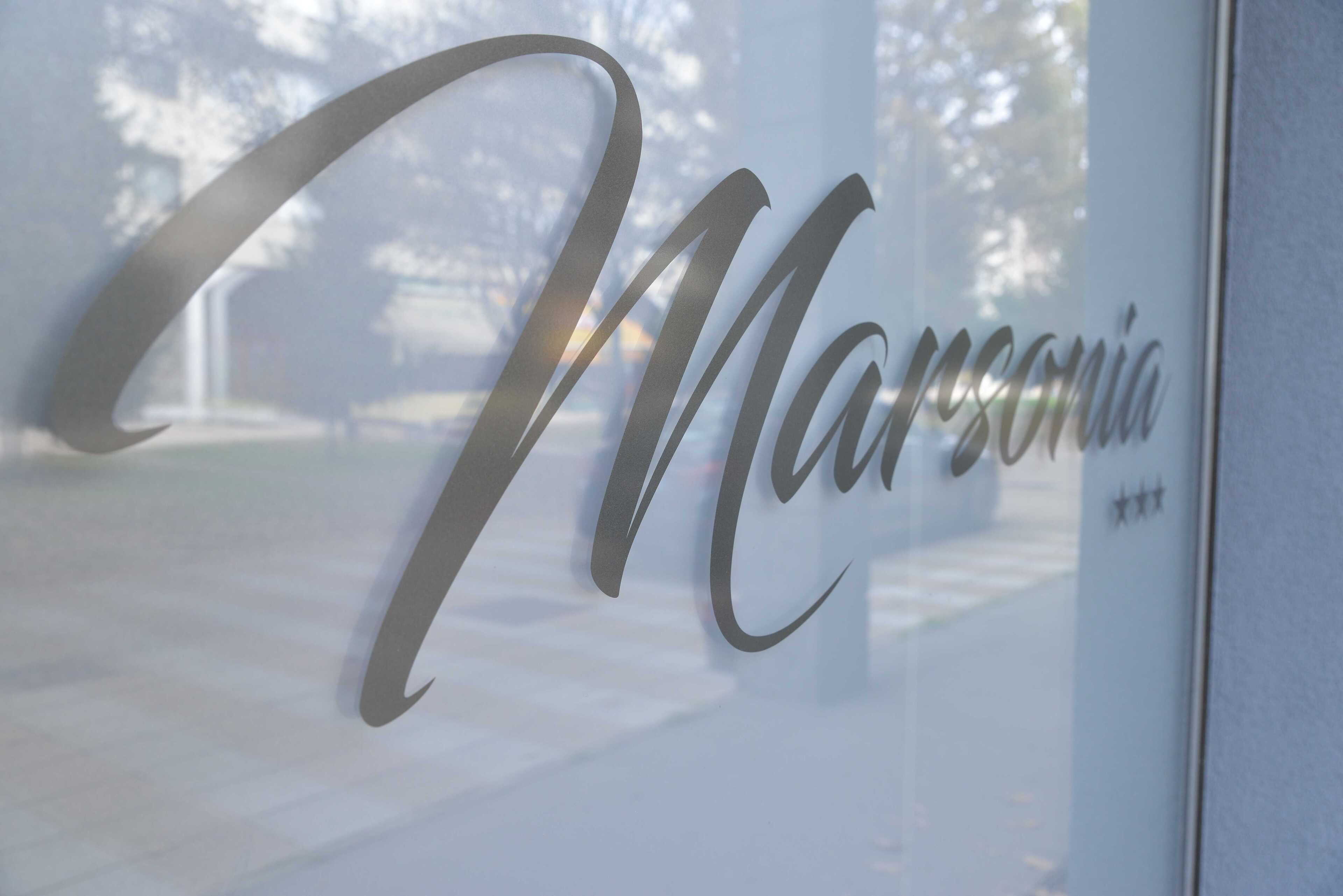 A glass window with the word "Marriott" in cursive script.