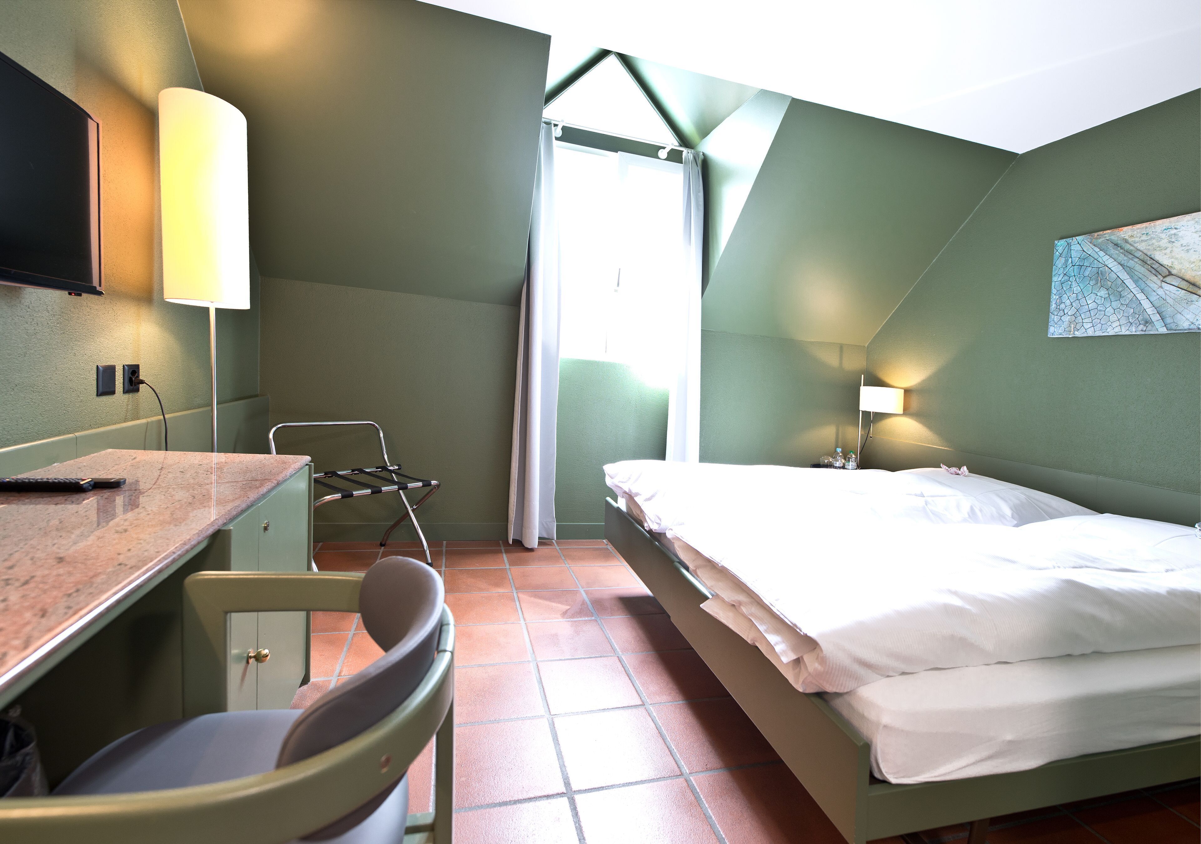 Premium bedding, desk, laptop workspace, blackout drapes