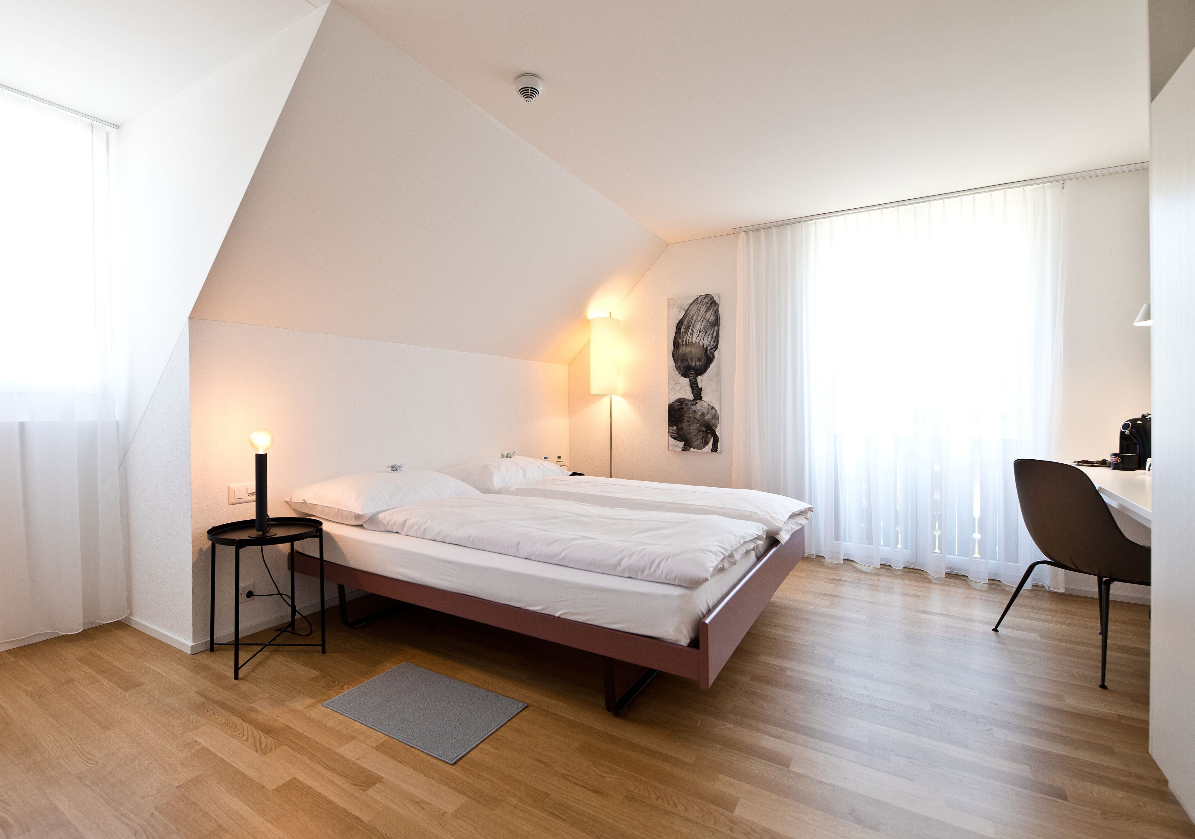 Premium bedding, desk, laptop workspace, blackout drapes