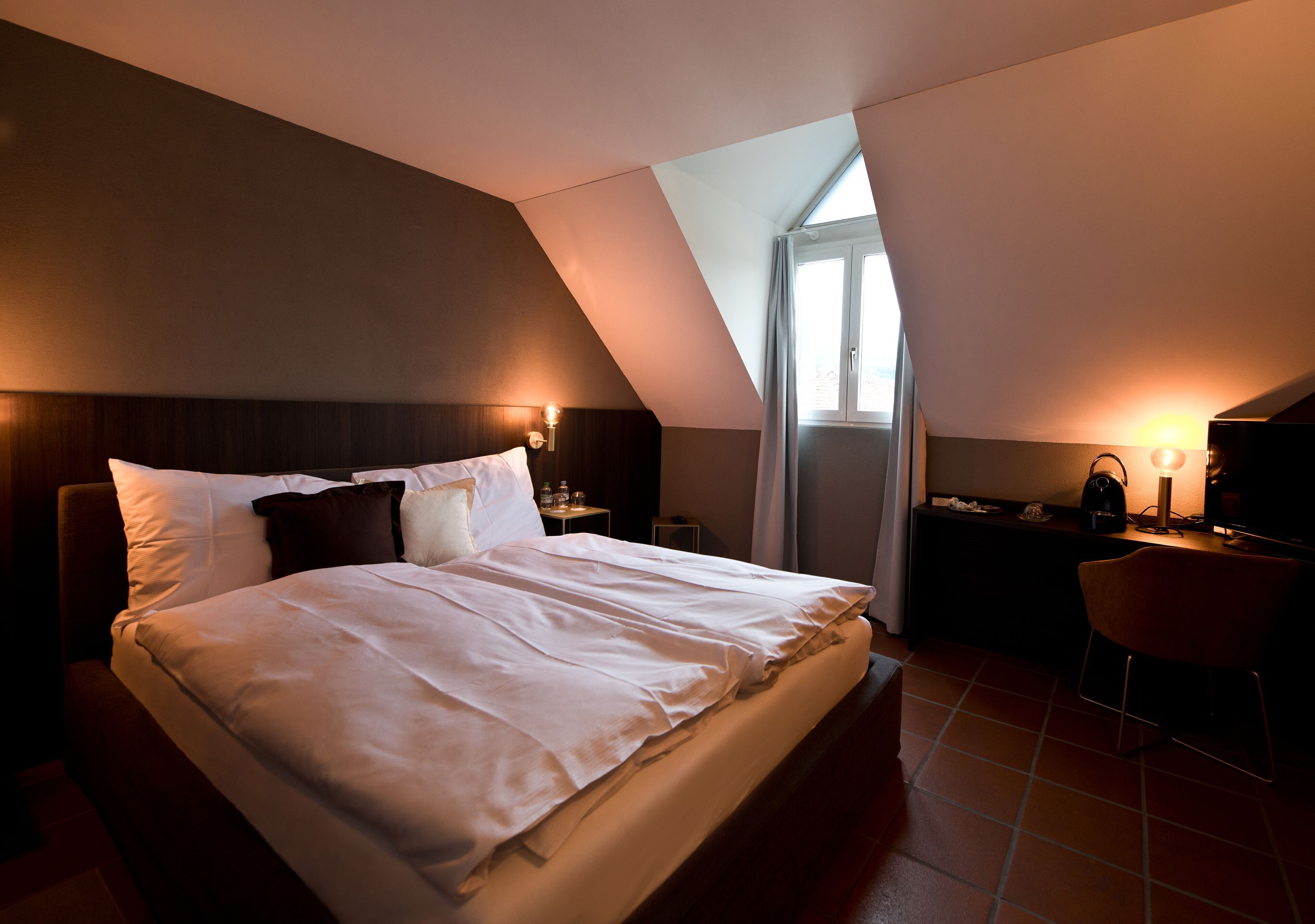 Premium bedding, desk, laptop workspace, blackout drapes