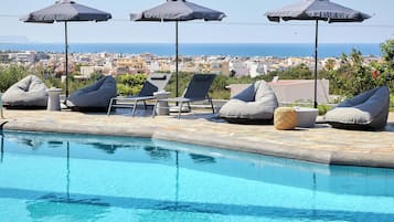 Outdoor pool, open 9:00 AM to 8:00 PM, pool umbrellas, pool loungers