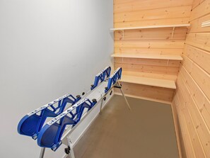 A staircase with wooden walls and a blue chairlift.
