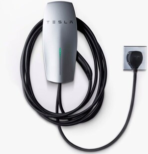 A Tesla charging station with a cable and a wall plug. - South Miami Gem • Mini Golf, Pool Table • Pool & BBQ (Cutler Bay)