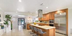 Enjoy cooking in this well-equipped kitchen with a central island and stainless steel appliances.