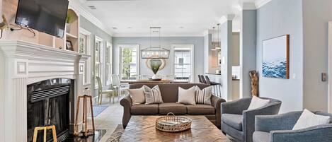 A spacious living room with a fireplace, a large sofa, and a coffee table.
