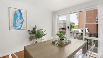 A dining area with a wooden table, chairs, and a map on the wall.
