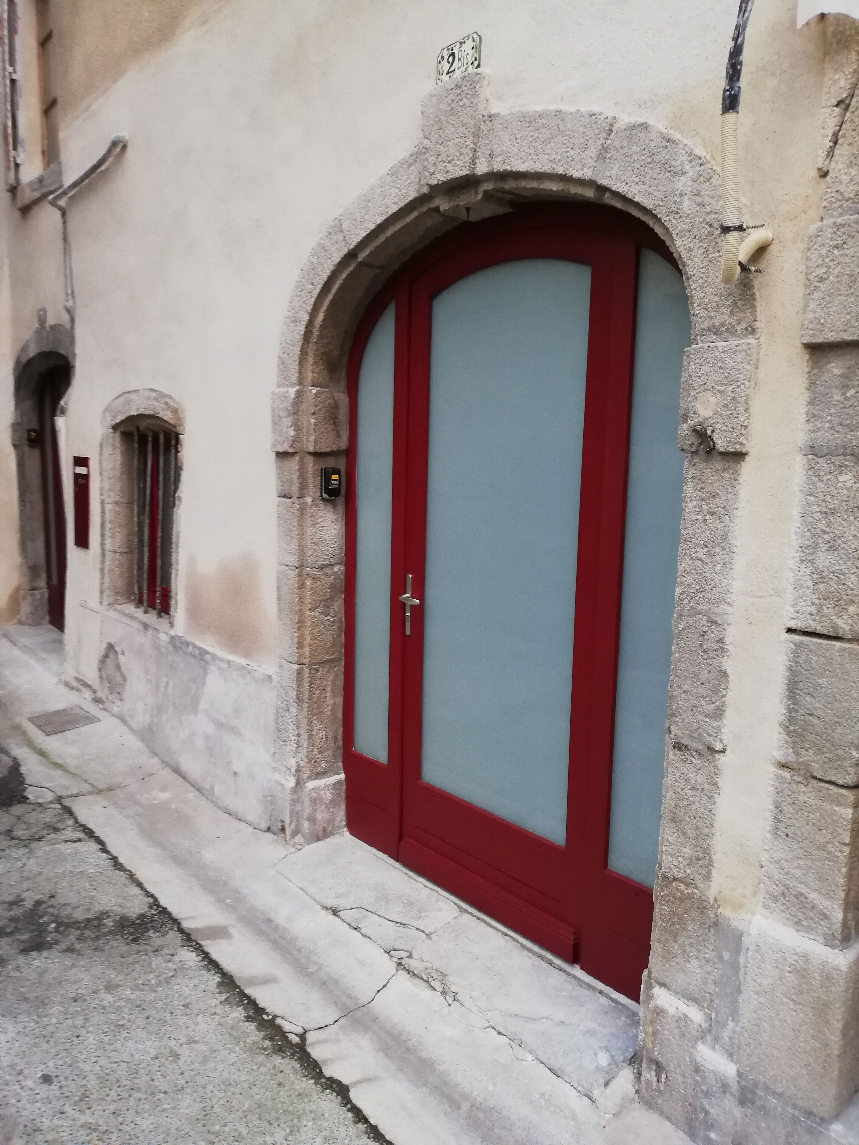 A building with a red door and a small window.