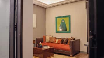 Ambiance One Bedroom Suite | Living area | 42-inch TV with cable channels, Netflix, streaming services