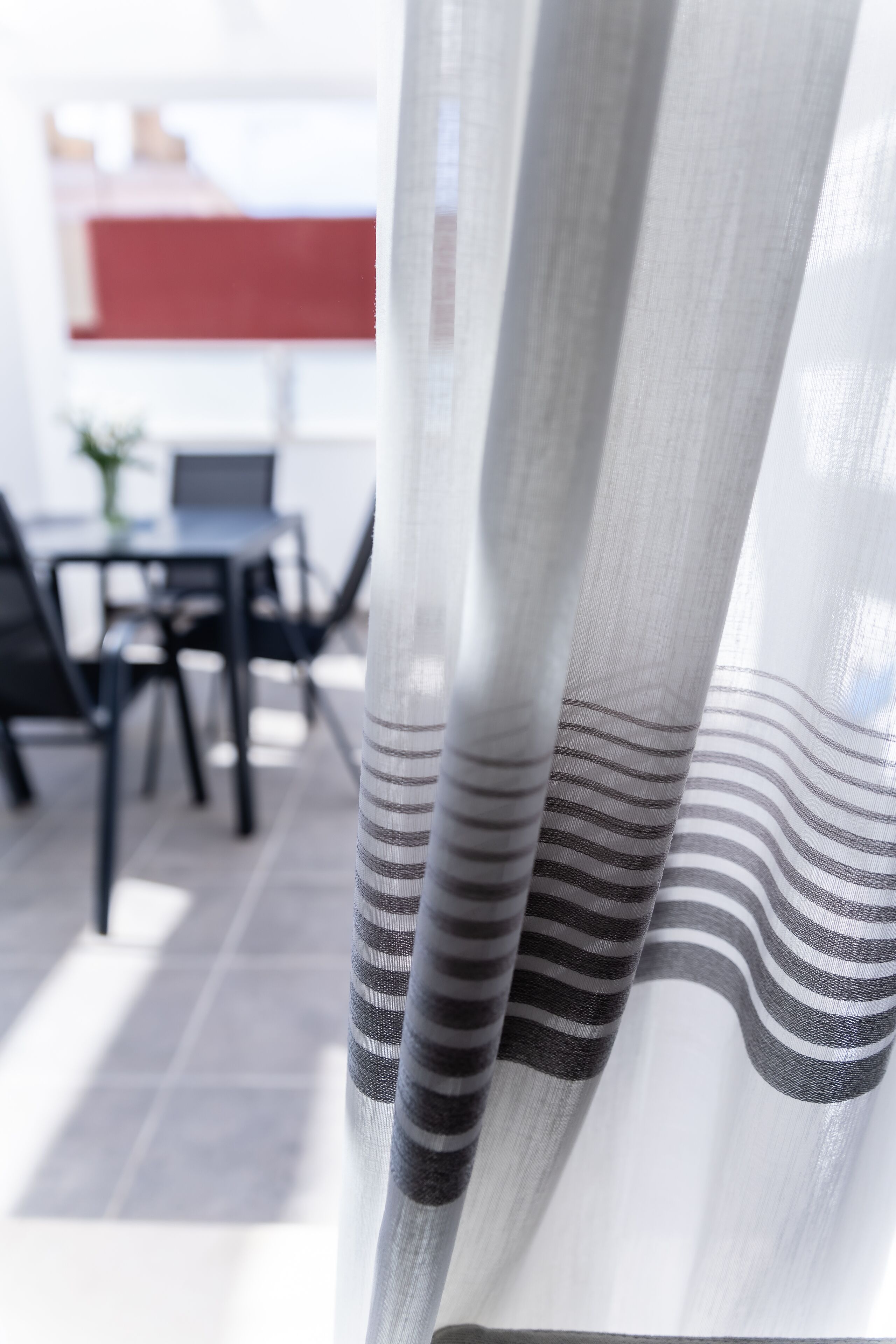 A close-up of a curtain with a striped pattern.