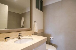 A bathroom with a sink, mirror, and toilet. - w* | 3BR Premium Cityview w/ Balcony in Miraflores (Miraflores)