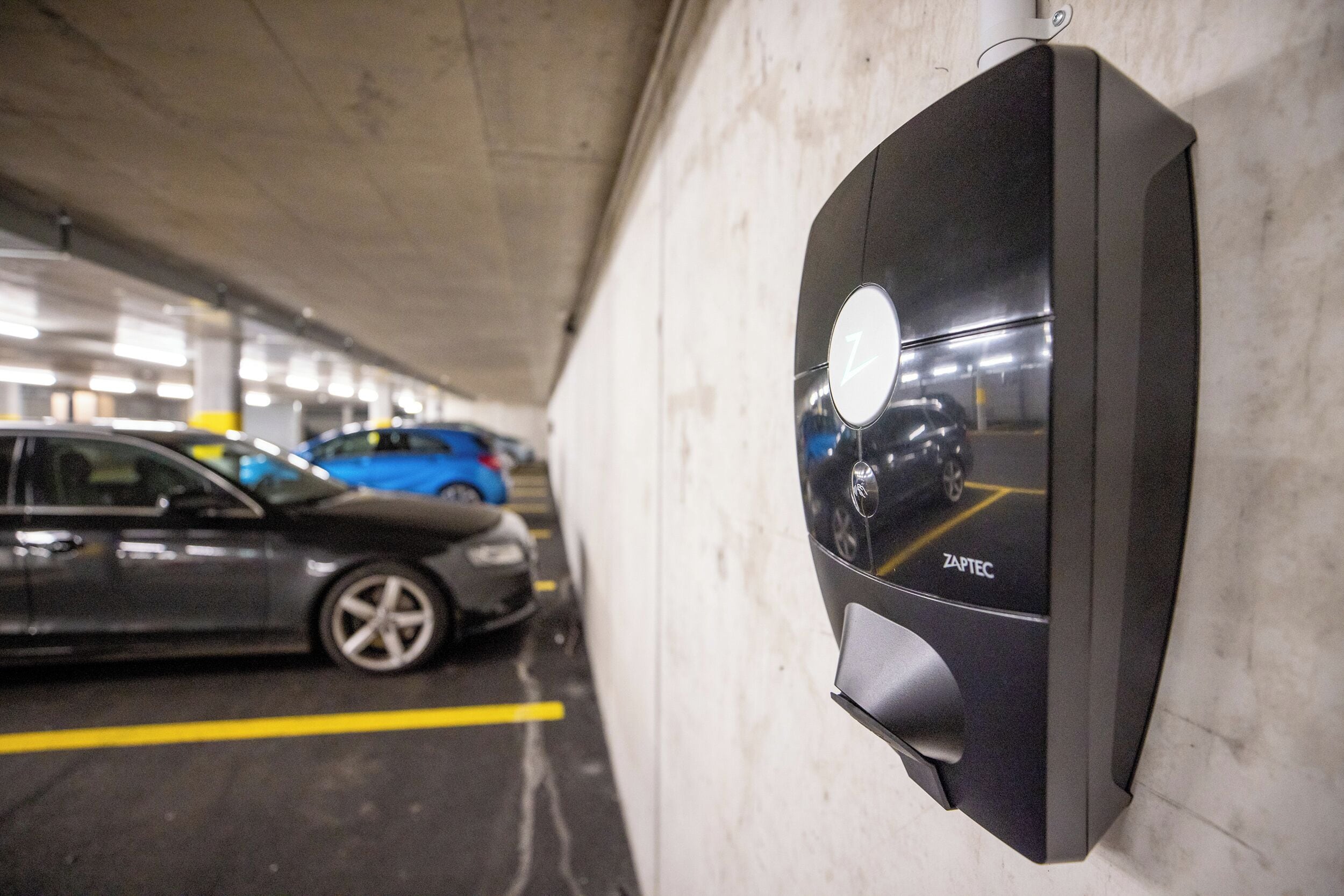 A parking garage with a ZAPTEC parking meter.