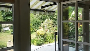 A conservatory with a view of a garden.