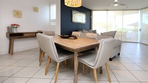 Enjoy meals in this dining area with a wooden table and comfortable leather chairs.