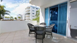 Enjoy a meal or a moment of relaxation on this balcony with a round table and four chairs.