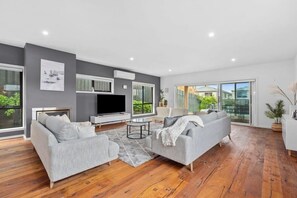 TV, offices - Waterways Retreat: Luxe Coastal Getaway with Pool (Ocean Grove)