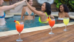 A poolside area with three drinks on a wooden table. - Mount Healthy Villas 1 Property -2 villas  6- bedrooms with spa & pool (Tortola)