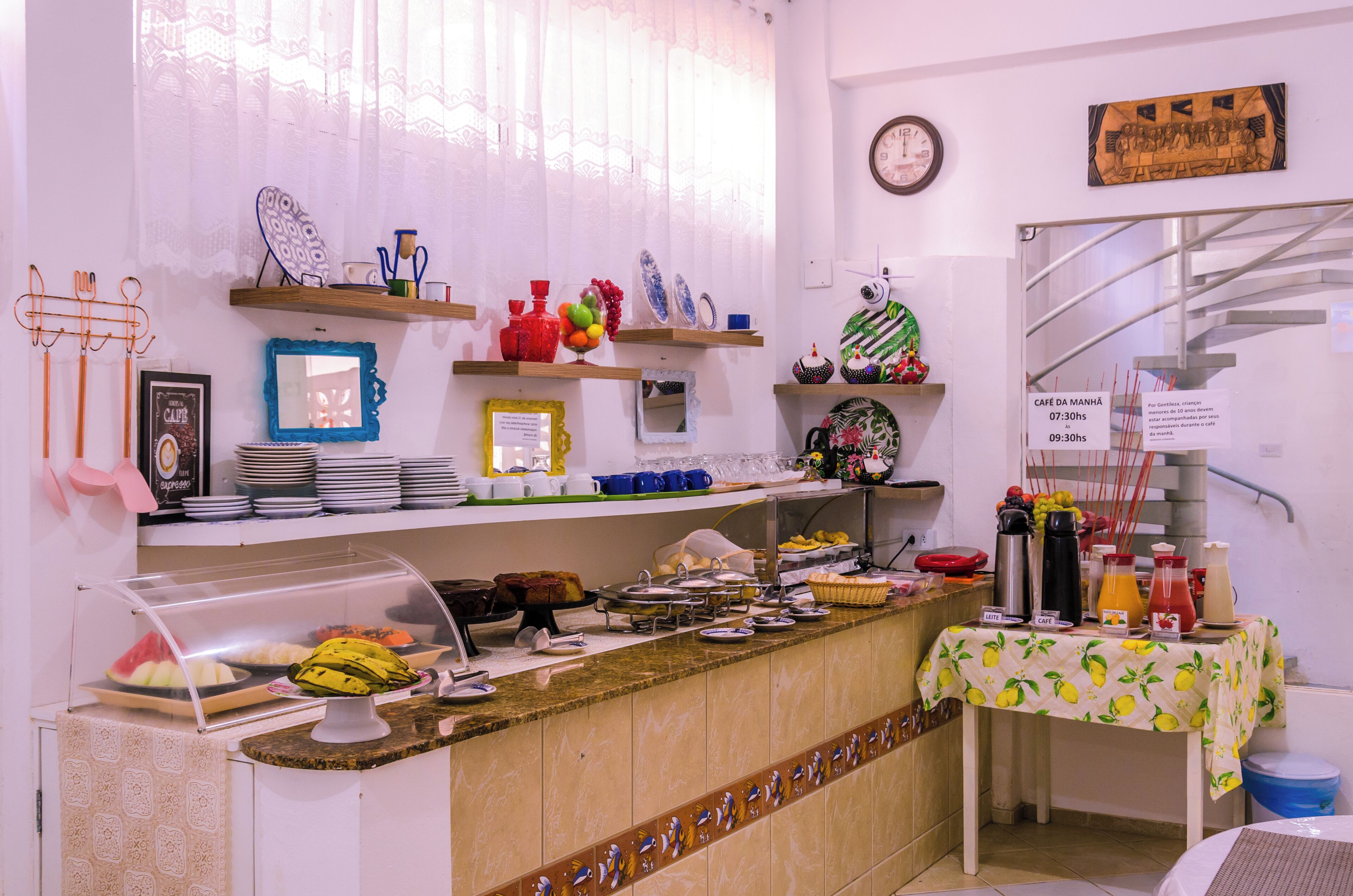 A buffet area with various food items and utensils.