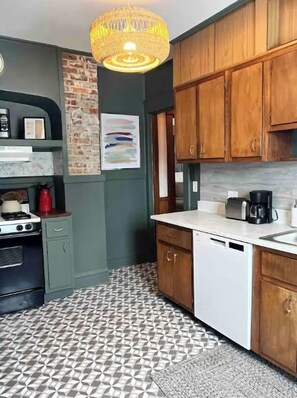 Enjoy cooking in this well-equipped kitchen with a stove, oven, and dishwasher.