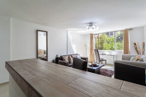 Suite Confort, 1 habitación | Área de sala de estar | Televisión de plasma 