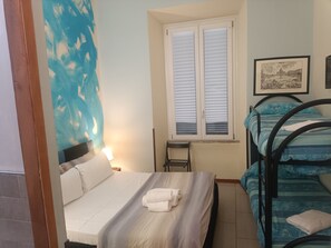 A bedroom with a bed, a desk, and a window. - Enjoy Roma (Rome)