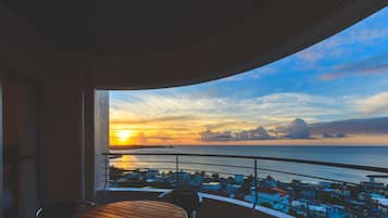 Enjoy breathtaking ocean views from this balcony with a table and two chairs.