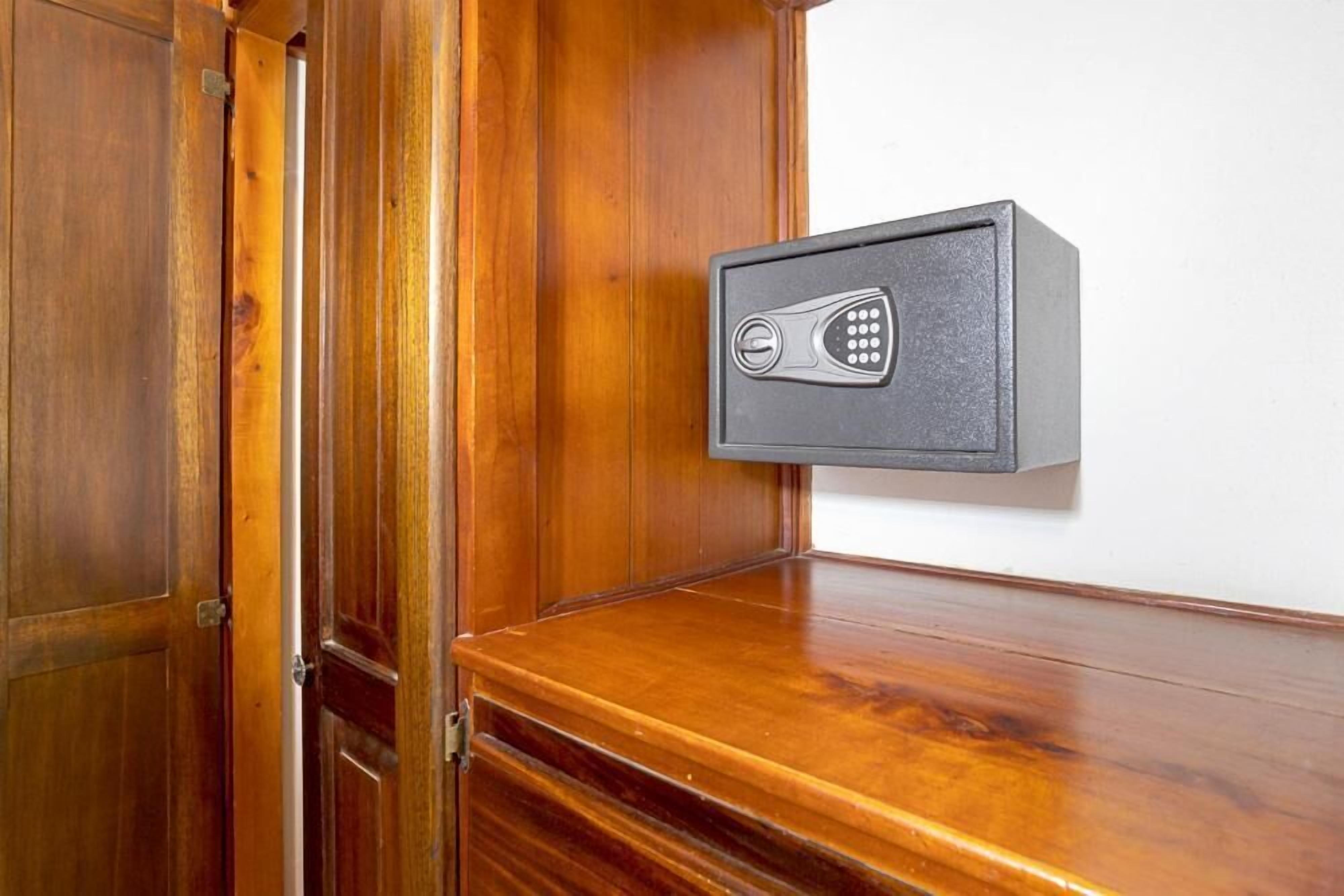 A wooden door with a metal security box mounted on the wall.