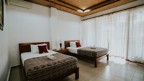 A hotel room with two beds, a wooden ceiling, and a large window with sheer curtains. - Jati 3 Bungalows (Ubud)