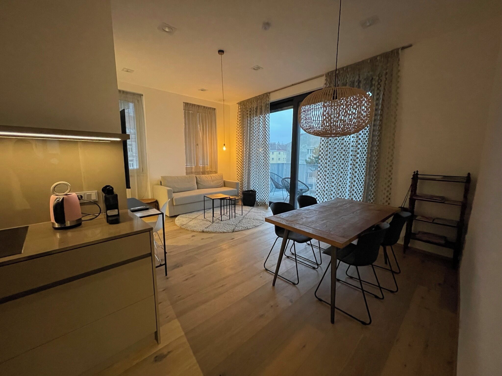 A modern apartment with a kitchen, dining area, and living space.